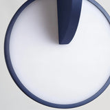 "Close-up of a modern pendant light disc with overlapping design."