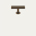 Antique brass T-bar cabinet pull with cylindrical post and round base on neutral background.