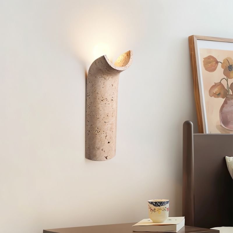 "Ilana travertine wall lamp featuring a unique curved design, adding a touch of modern elegance to any space."