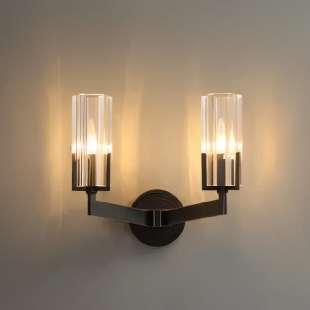 "A modern black wall lamp with a minimalist yet luxurious design, featuring a sleek iron base and cylindrical glass shades that cast a soft, ambient light."