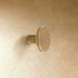 Round mushroom cabinet knob with textured top, cylindrical stem, brushed metal finish, white studio background, front view.