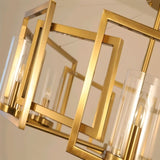 "A close-up view of a modern chandelier with a geometric brass frame and cylindrical glass shades, showcasing the detailed design."