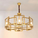 "A modern chandelier with a geometric brass frame and cylindrical glass shades, suspended from a ceiling against a light background."