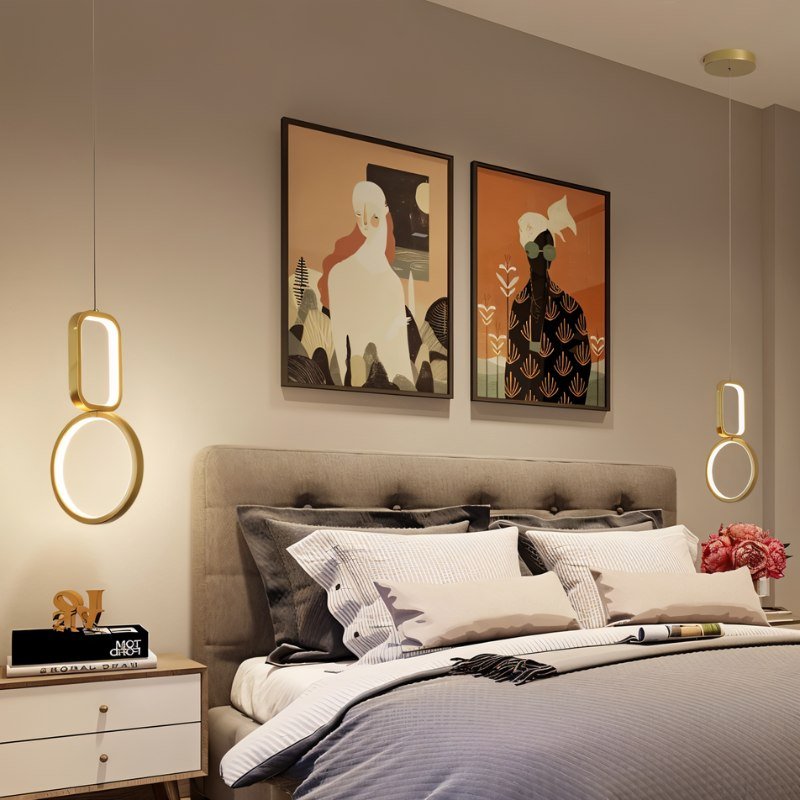 "Geometric pendant lights with metal frames and acrylic diffusers, flanking a bed with artwork in a bedroom."