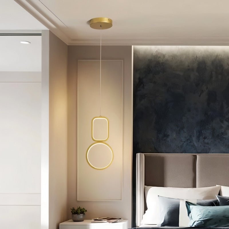 "Geometric pendant light with metal frame and acrylic diffusers, hanging in a bedroom."