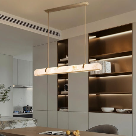 "Modern alabaster and copper linear chandelier illuminating a contemporary kitchen island."