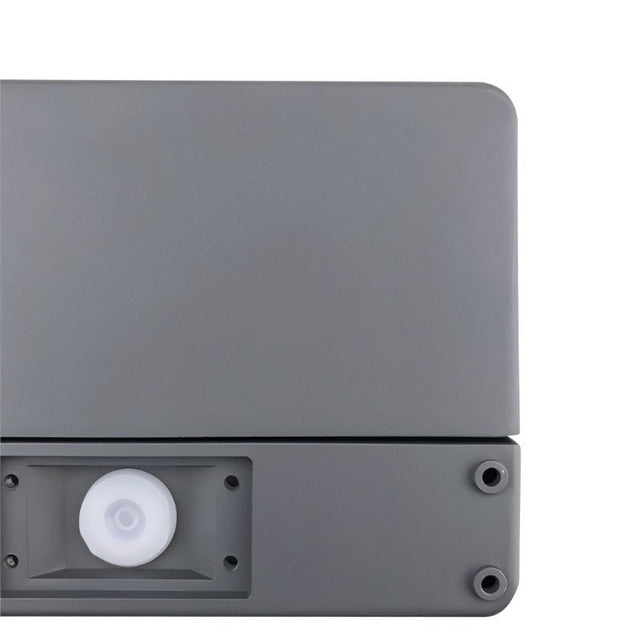 "Close-up of a minimalist rectangular outdoor wall lamp made of aluminum with a PC diffuser."