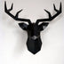 Black geometric low-poly deer head wall mount sculpture with antlers on white background.