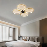 "Modern ceiling light with four circular LED rings in a clover design, providing bright illumination in a contemporary bedroom."