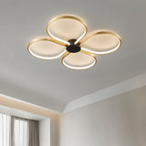 "Close-up of a modern ceiling light with four circular LED rings in a clover-like formation, showcasing its design."