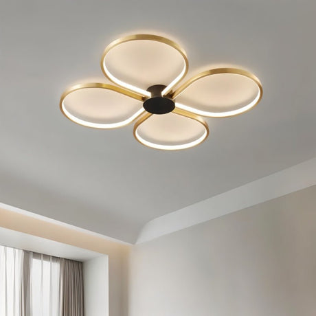 "Close-up of a modern ceiling light with four circular LED rings in a clover-like formation, showcasing its design."