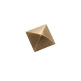 "A pyramid-shaped antique brass cabinet knob with a classic, geometric design, suitable for traditional and transitional interiors."
