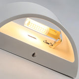 "Close-up detail of a modern curved rectangular gypsum wall lamp showcasing the smooth matte finish and the light source casting a warm glow."