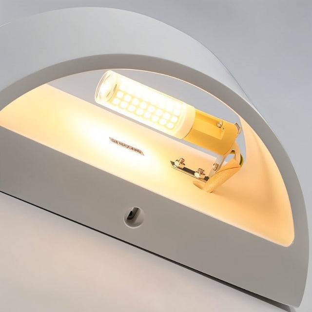 "Close-up detail of a modern curved rectangular gypsum wall lamp showcasing the smooth matte finish and the light source casting a warm glow."