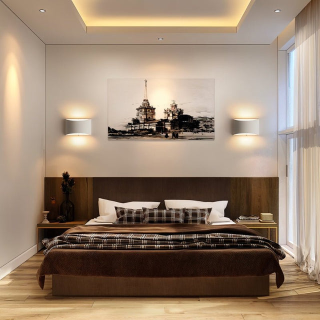 "Pair of modern curved rectangular gypsum wall lamps flanking a framed artwork in a contemporary bedroom, providing soft ambient lighting."