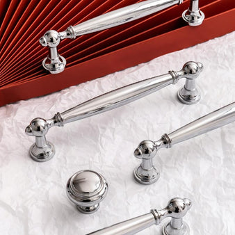 "Luxury brass knobs and pull bars with a polished finish and intricate detailing, ideal for classic and transitional interiors."