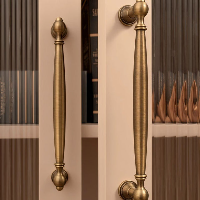 "Antique brass pull bars on library cabinets, showcasing an elegant, timeless design for luxury interiors."