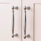 "Polished chrome brass pull bars on cabinet doors, showcasing an elegant, timeless design for luxury interiors."