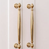 "Polished gold brass pull bars on cabinet doors, showcasing an elegant, timeless design for luxury interiors."