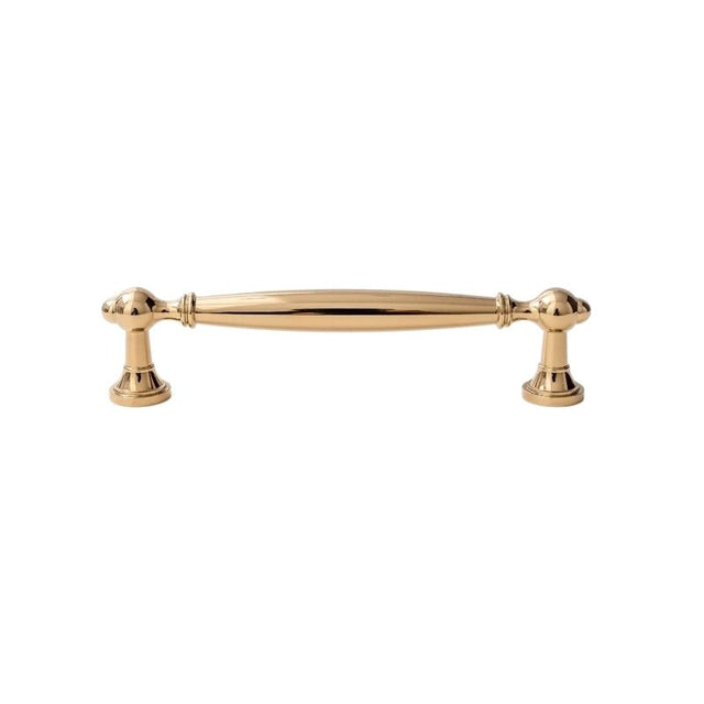"A polished gold brass pull bar with a classic, elegant design, isolated on a white background."