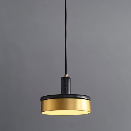 "A modern pendant light with a black marble and brass design hangs from a gray background, showcasing its minimalist aesthetic."