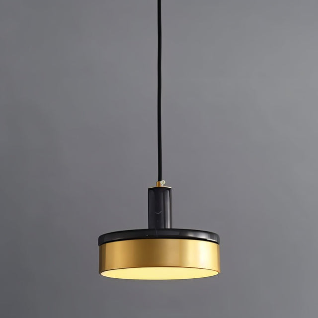 "A modern pendant light with a black marble and brass design hangs from a gray background, showcasing its minimalist aesthetic."