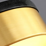"Close-up of the brass and black marble detailing on a modern pendant light, highlighting the materials and craftsmanship."