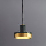"A modern pendant light with green marble and brass accents hangs from a gray background, showcasing its elegant design."