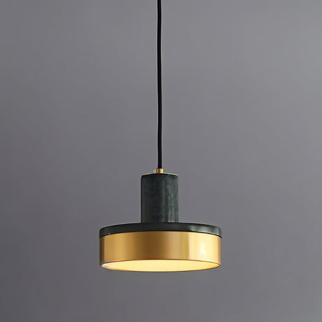 "A modern pendant light with green marble and brass accents hangs from a gray background, showcasing its elegant design."