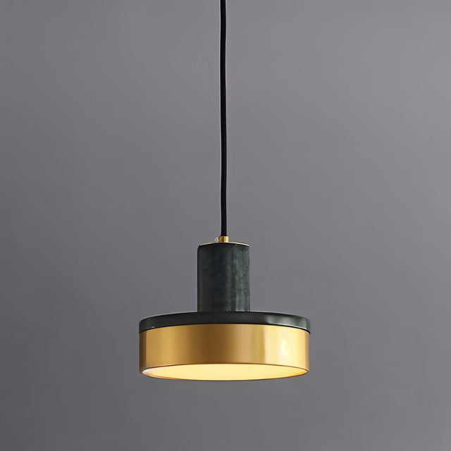 "A modern pendant light with green marble and brass accents hangs from a gray background, showcasing its elegant design."