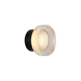 "A modern, minimalist wall lamp with a circular glass diffuser and a sleek black frame, emitting a soft, ambient glow."