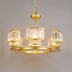 Gold chandelier with crystal cylinder shades and three surrounding lights on neutral background.