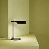 "Minimalist black table lamp with a sleek metal design, featuring an adjustable shade and sturdy base for modern interiors"