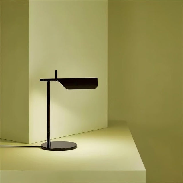 "Minimalist black table lamp with a sleek metal design, featuring an adjustable shade and sturdy base for modern interiors"