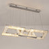 Modern rectangular crystal chandelier with brushed nickel frame and warm LED lighting suspended from ceiling.