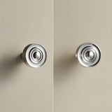 "Pair of nickel-finished brass knobs with a concentric ring design and ridged surface, suitable for cabinets and drawers in modern and transitional spaces."