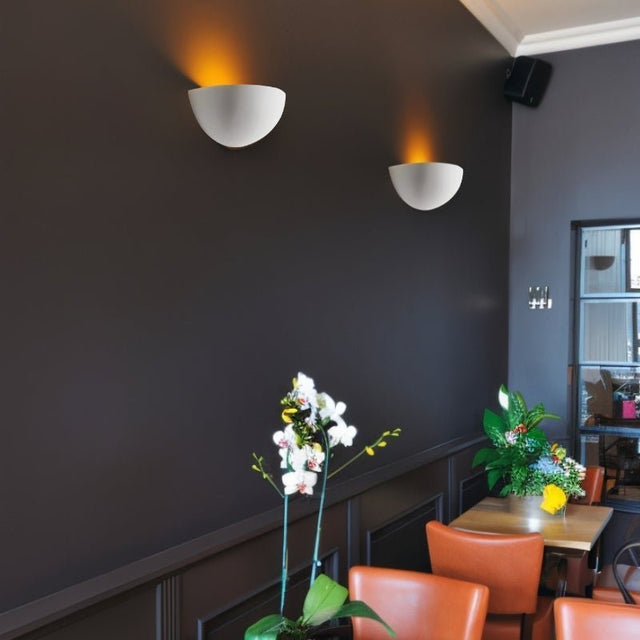 "Sleek gypsum and aluminum wall light fixtures in a contemporary setting, casting soft light upward and enhancing the ambiance of modern spaces like dining rooms and living areas."