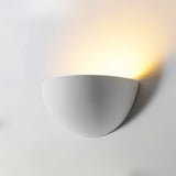 "Minimalist half-sphere wall light made from gypsum and aluminum, designed to direct soft light upward, perfect for contemporary hallways, bedrooms, and living rooms."