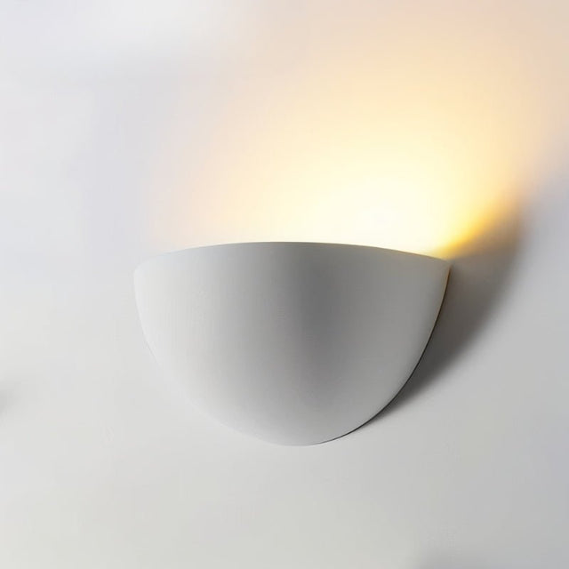"Minimalist half-sphere wall light made from gypsum and aluminum, designed to direct soft light upward, perfect for contemporary hallways, bedrooms, and living rooms."