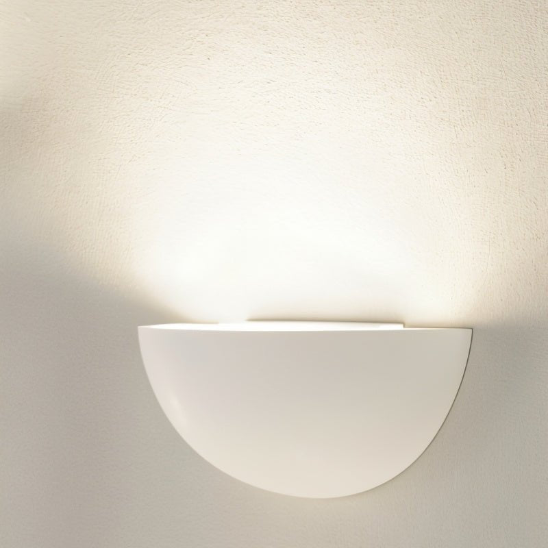 "Modern gypsum and aluminum half-sphere wall light fixture providing soft, upward light, ideal for creating a serene atmosphere in contemporary spaces."