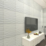 Angled view of Lavic 3D wavy wall panels behind a mounted TV and white dresser, showcasing the panel's depth and wave pattern.