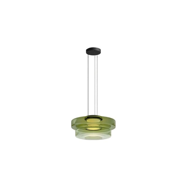 "A green glass disc pendant light with tiered design."