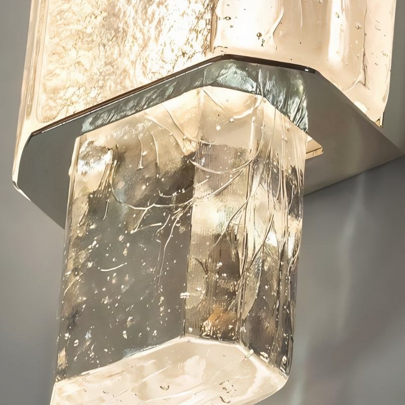 "Close-up of a modern crystal wall lamp with a textured glass diffuser and metal frame."