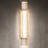 "Modern crystal wall lamp with a vertical, cylindrical design, providing soft, diffused lighting in a contemporary space."