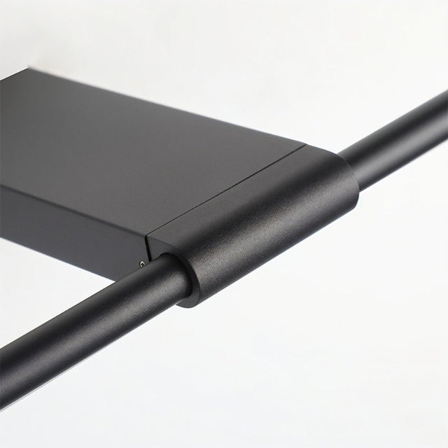 "Close-up detail of the black metal and PC construction of the minimalist Lisorva wall lamp, showcasing its sleek design."