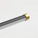 "Close-up detail of the brass accents on the minimalist Lisorva wall lamp, highlighting its sleek design and construction from metal and PC."