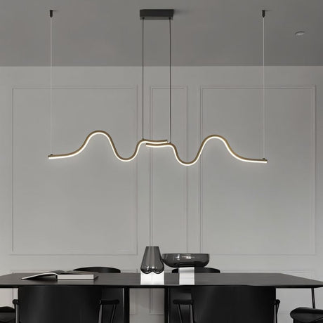 "A wave-like pendant light with a sculptural design, suspended above a modern dining table, providing diffused illumination."