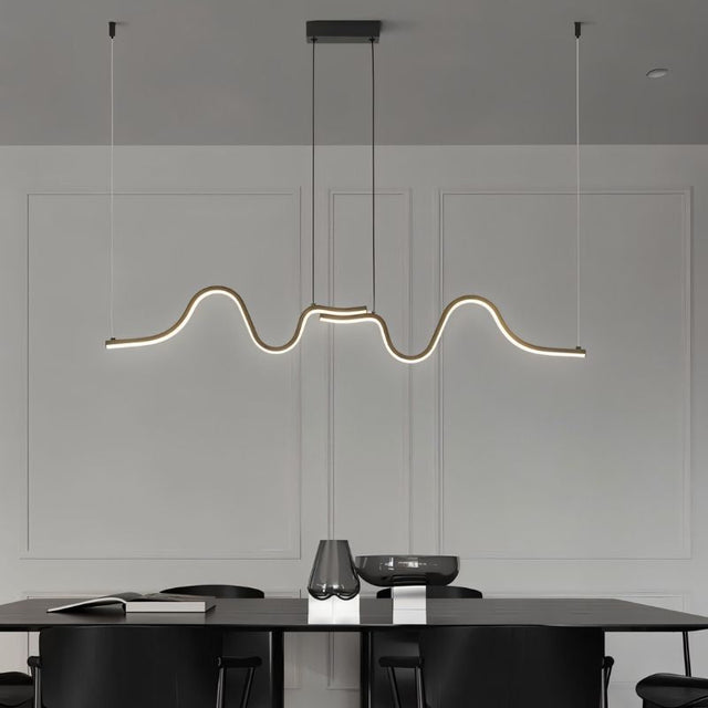 "A wave-like pendant light with a sculptural design, suspended above a modern dining table, providing diffused illumination."