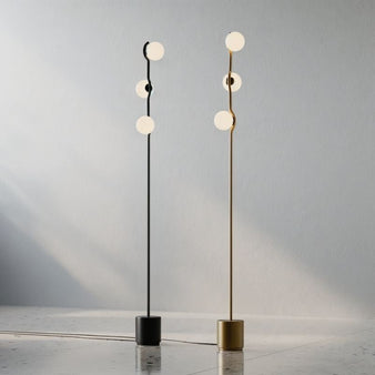 "black and gold floor lamps with sleek curved metal frame and frosted glass shades"