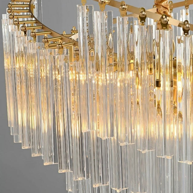 "A detailed view of a crystal rod chandelier with a brass frame, showing the layered design and warm light."
